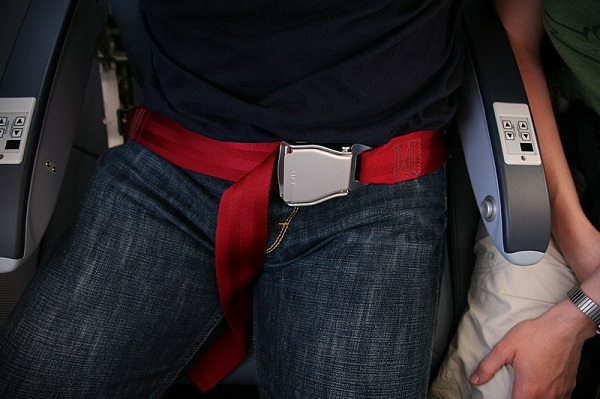  Seat belt on an airplane, buckled-up. 